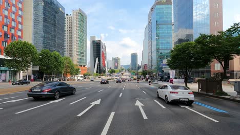 Seoul-traffic-in-Yeongdong-daero-road-Gangnam-District---2021-06-27---Ipark,-Korean-Tradetower-building-near-COEX,-driver's-POV-in-wide-multilane-road-in-the-center-Seoul-downtown