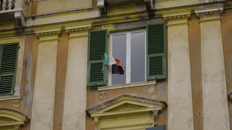 Still-shot-of-the-Italy-flag-waving-in-the-exterior-of-an-apartment