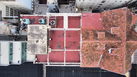 Vertical-straight-down-view-overlooking-at-mueblería-diaz,-the-chalet-de-la-9-de-Julio-in-downtown-buenos-aires,-establishing-aerial-tracking-shot
