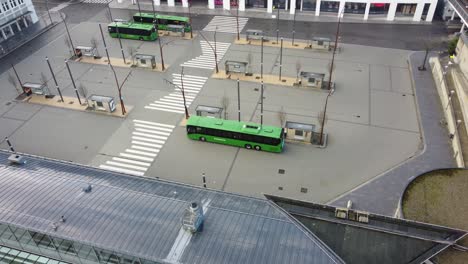 Green-colored-buses-in-Sandnes-city-terminal---Kolumbus-public-transportation-service-in-Norway---Aerial