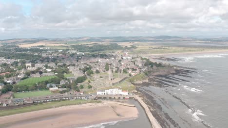 Dolly-forward-drone-shot-of-St-Andrews-seaside-university-town-over-the-sea