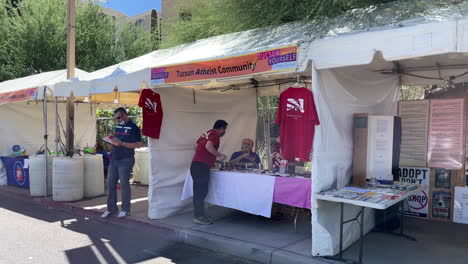 Man-Talking-In-Front-Of-Atheist-Community-Booth-At-The-Tucson-Meet-Yourself-Festival-In-Arizona