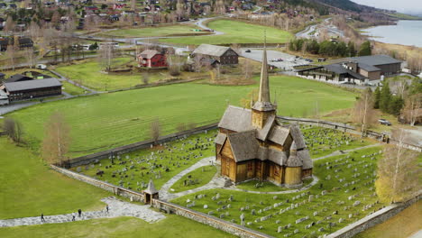 Scenic-View-On-Lom-Stavkyrkje---Lom-Stave-Church-In-Norway-During-Autumn---aerial-drone-shot
