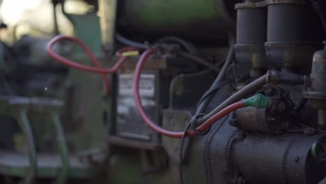 Closeup-Shot-Of-Battery-And-Components-Of-An-Antique-Tractor