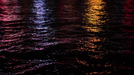 Reflection-of-the-city-light-on-the-sea-at-night-time