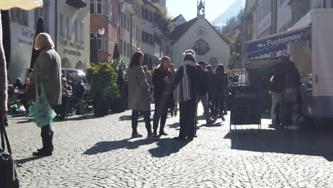 Austrian-people-gather-on-the-street,-in-front-of-the-church,-and-in-the-middle-of-the-building
