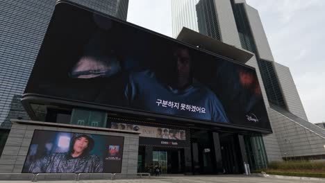 Coex-Artium-and-World-Trade-Center-complex-in-Seoul,-South-Korea-with-a-giant-electronic-billboard-at-the-entrance---establishing-shot