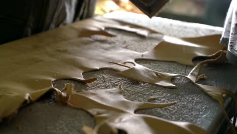 Worker-Cutting-Leather-Gloves-On-Press,-Manufacturing-Process-On-Industrial-Press