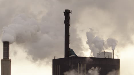 Panning-apocalyptic-scene-shot-of-a-factory-billowing-out-smoke