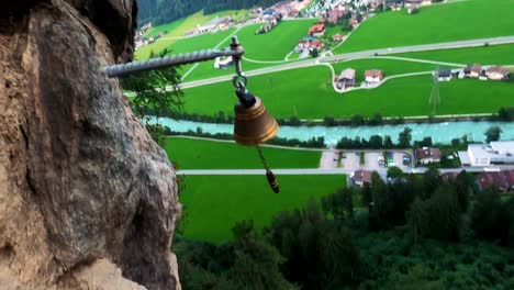 POV-shot-of-a-climber-who-rings-a-bell,-which-is-located-at-very-high-altitude