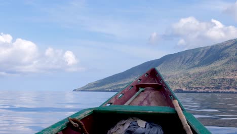 Taking-a-local-traditional-fishing-boat-to-a-remote,-secluded-tropical-island,-overlooking-the-bow,-watching-Atauro-Island,-Timor-Leste,-Southeast-Asia