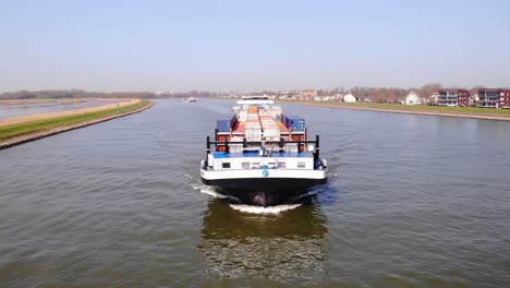 Aerial-Across-Forward-Bow-Of-Missouri-Cargo-Container-Ship-Along-River-Noord-On-Sunny-Clear-Day-In-Alblasserdam