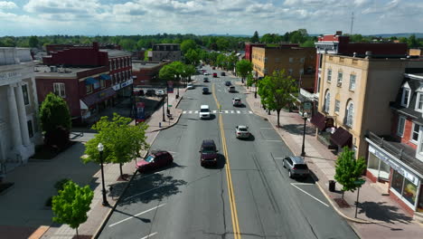 Aerial-straight-flight-over-traffic-on-main-street-of-small-town-in-America
