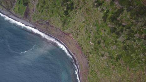 A-birds-eye-view-looking-down-at-a-beach-in-Madeira