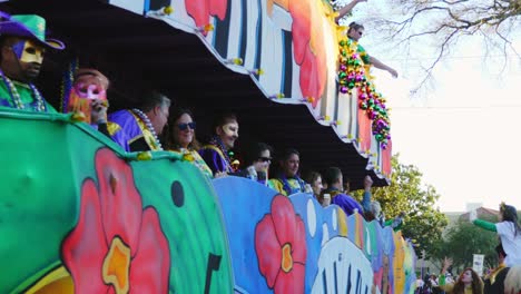 Riders-toss-beads-from-Mardi-Gras-float