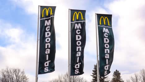 Three-black-McDonalds-banners-of-fast-food-restaurant-chain-waving-in-a-strong-wind