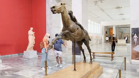 Bronze-statue-of-a-horse-and-young-jockey-Retrieved-in-pieces-from-the-shipwreck-off-Cape-Artemision-in-Euboea,-display-in-the-National-Archaeological-Museum-Athens,-Greece-on-10-14-2021