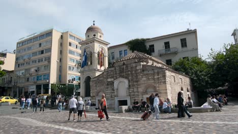Pan-shot-of-buildings,-panagia-pantanassa-church-and-people-at-Monastiraki-Square
