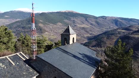 Drone-shot-flying-over-a-medieval-church-in-the-Pyrenees-Mountains,-Spain