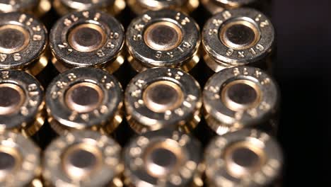 very-slow-close-up-of-9mm-bullets-for-pistol,-personal-protection-weapon,-or-rifle