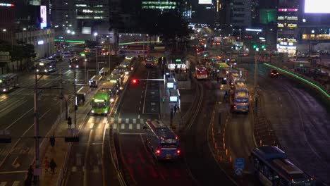 City-life-in-Seoul-South-Korea-with-an-establishing-shot-of-a-central-bus-stop-at-night