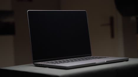 Cinematic-footage-of-an-Apple-M1-MacBook-Pro-14-inch-with-an-overhead-light-filmed-at-a-tight-focal-length-in-4k-in-slow-motion-shot-in-the-studio-with-controlled-light-with-some-slow-movement