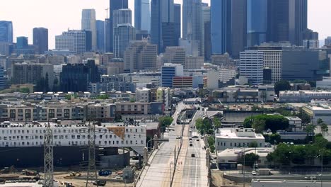 Drone-View-Of-Urban-Buildings-In-Downtown-Los-Angeles-over-First-Street-Bridge-Cityscape-And-Skyline