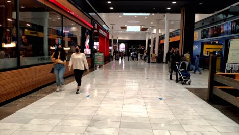 POV-Walking-Through-Third-Floor-Past-Shopper-At-As-Cancelas-Shopping-Center-In-Galicia,-Spain