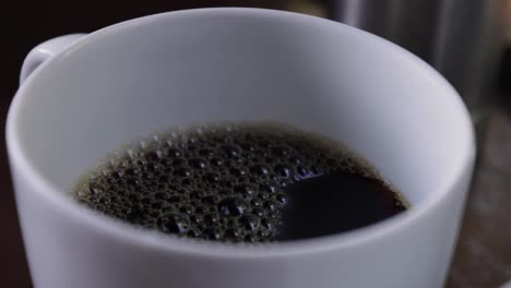 Slow-motion-view-of-a-morning-black-coffee-cup