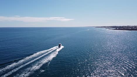 Drone-Follow-Shot-Of-Fast-White-Yacht-And-Shimmering-Sea-Australia