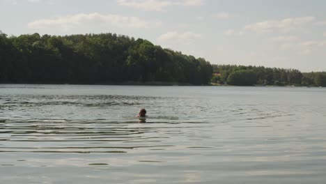 Shirtless-Man-Swims-On-The-Lake-Of-Jezioro-Glebokie-In-Poland