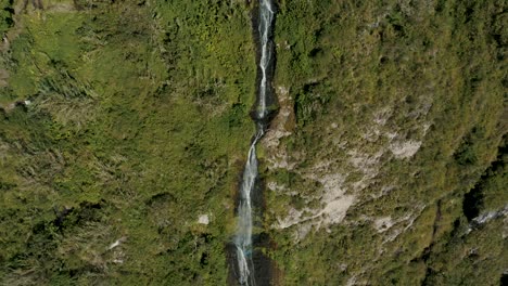 Water-Cascading-Down-Lush-Mountains,-Manto-de-la-novia-Waterfall-In-Ecuador---aerial-drone-shot