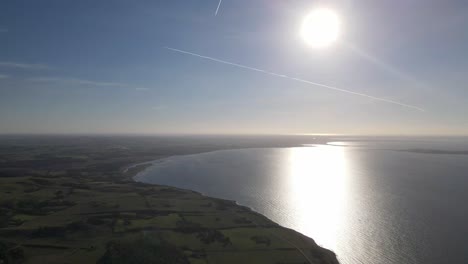 Aerial-view-of-the-incredible-beautiful-coastline-with-sun-and-blue-sky-in-Odsherred,-Zealand,-Denmark