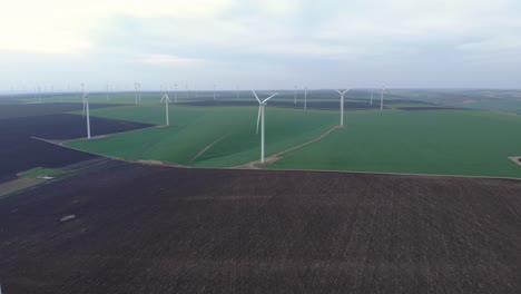 Wind-Farm-Green-Energy-Production-Field,-Aerial-Approaching-Drone-View