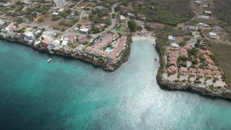 Aerial-orbit-over-the-small-beach-hidden-in-the-rocky-shore-of-Curacao