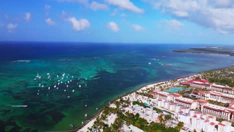 Aerial-drone-view-of-Bavaro-resort-in-Punta-Cana,-Dominican-Republic,-beach-and-touristic-coast,-high-flight