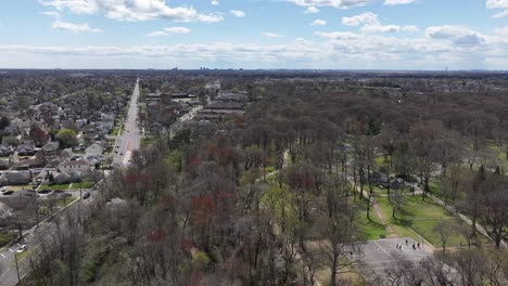 An-aerial-time-lapse-on-a-sunny-day-with-clouds-flying-over-a-park
