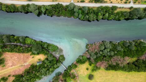 Overhead-view-of-the-turquoise-waters-of-the-Cochamo-River-surrounded-by-trees,-Cochamo-Valley,-Chile