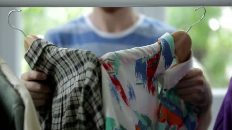 Man-Choose-Hanged-Shirts-Apparel-Style-Options-On-Closet-Garment-Rack