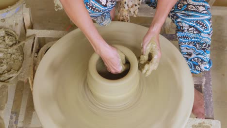 Sculpt-molding-a-pottery-pot-with-patience-top-down-shot