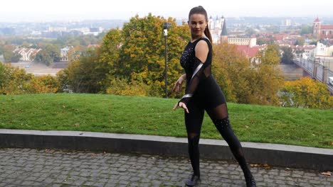 Fast-passed-female-dancer-dancing-outside-in-front-of-amazing-city-view