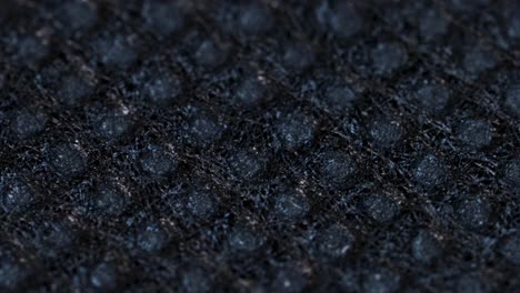 Black-textile-cloth-surface-texture,-macro-shot-close-up-view-with-rotation-motion