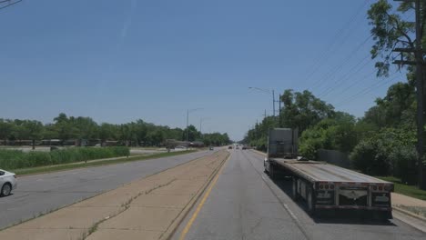 Traveling-in-Illinois-State-Tollway-roads-and-streets-construction-slow-traffic-at-rush-hour-flatbed-truck-on-right-side