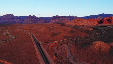 Morning-aerial-panorama-of-southwest-highways-approaching-Red-Rock-Canyon-near-a-small-rural-mountain-community