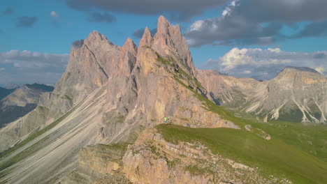 Hike-on-Seceda-mountain-cliffs-edge-looking-down-across-idyllic-South-Tyrol-vibrant-valley-scenery