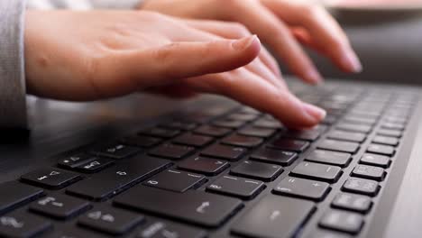 Laptop-keyboard-female-hands-typing-close-up-wide-angle-shot