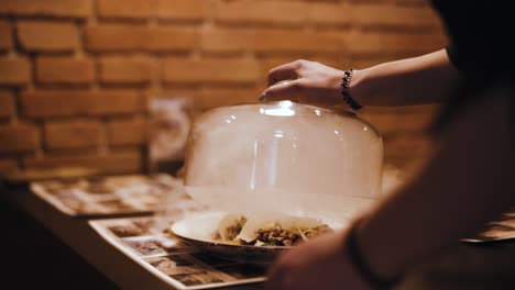 waitress-picking-up-a-bowl-with-smoked-dish