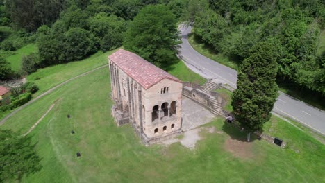 Aerial-view-of-Santa-Maria-del-Naranco-aged-catholic-church-with-tourists-visiting-it