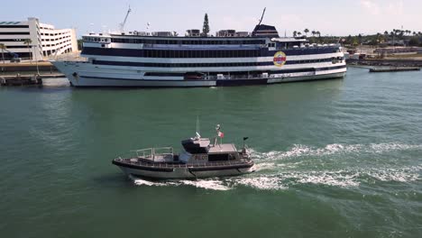Silver-pilot-boat-motors-beside-cruise-ship-to-pick-up-pilot-when-vessel-enters-the-open-sea