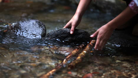 Romanian-girl-plays-with-sticks-in-the-water-2